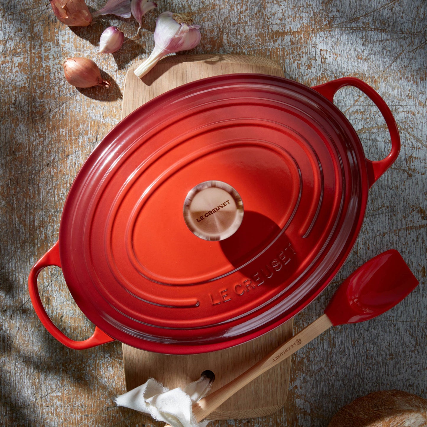 Signature Cast Iron 8-quart Cerise Oval Dutch Oven with Copper Knob